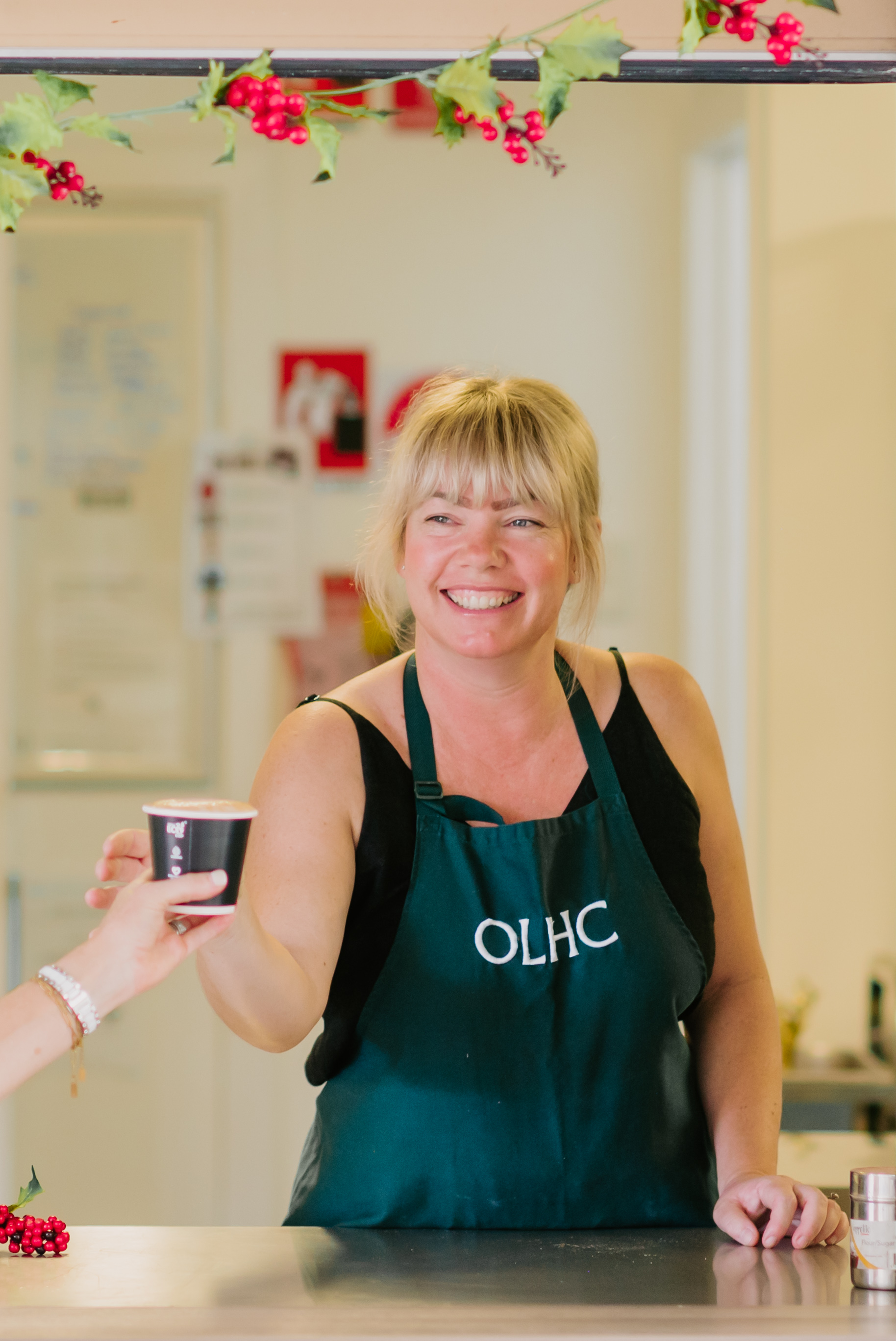 School community member serving refreshments at a school event, highlighting a welcoming, inclusive and connected school community