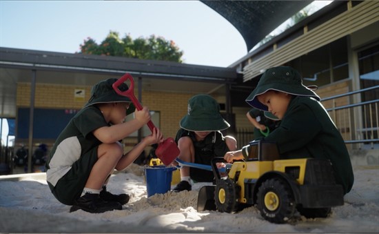 Young children engaged in outdoor sensory play, highlighting early learning, exploration and play‑based development