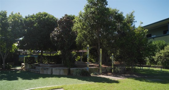 Wide view of shaded school grounds and garden spaces, reflecting outdoor learning, wellbeing and connection with nature